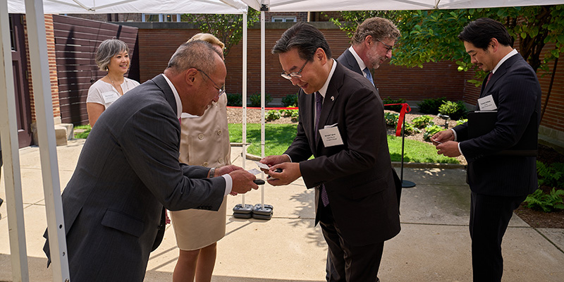 Hideya Sadayasu (left), President of the Imperial Hotel, Ltd. greets Hiroshi Tajima, Consul-General of Japan, Chicago.