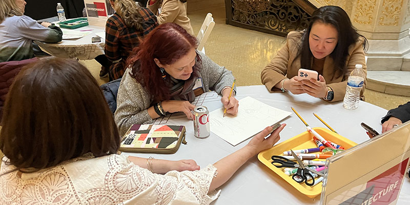  	Educators collaborating on a contemporary Chicago World’s Fair pavilion during a workshop at the Rookery.