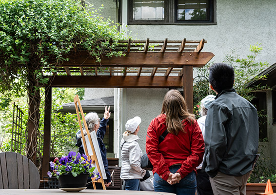 A house volunteer points out architectural detail to guests
