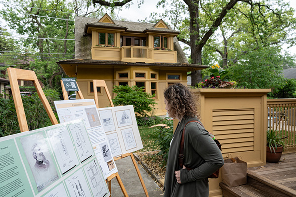 A guest stops to read research boards at Goodrich House
