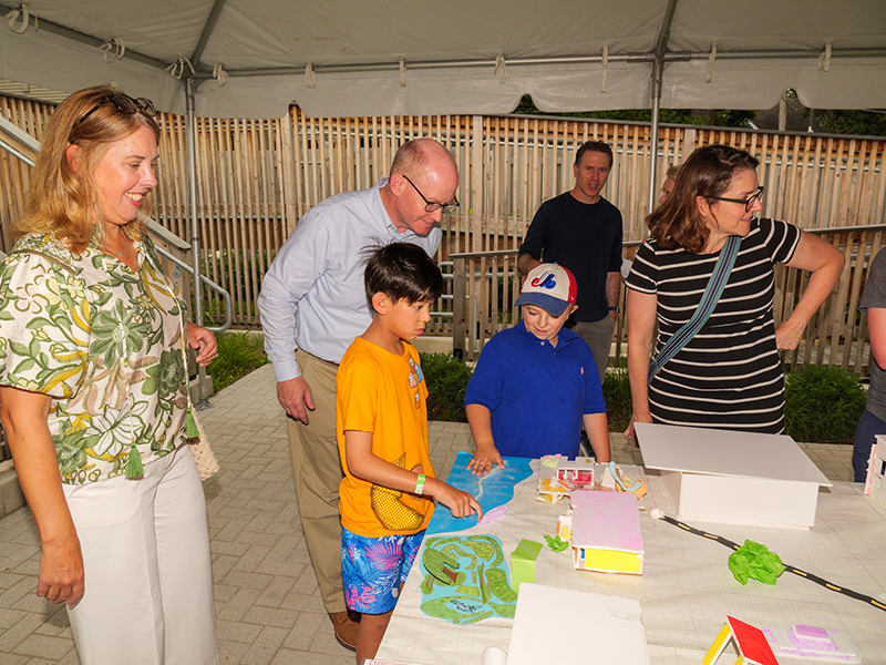 Oak Park Village President Scaman and Senate President Harmon examine student architectural models