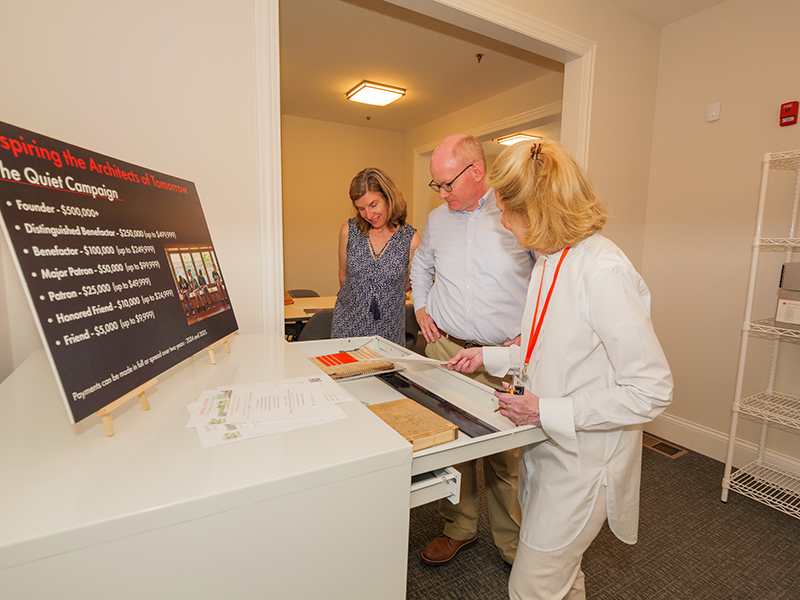 Adams, Harmon, and Lynch view objects in the Trust’s Archive