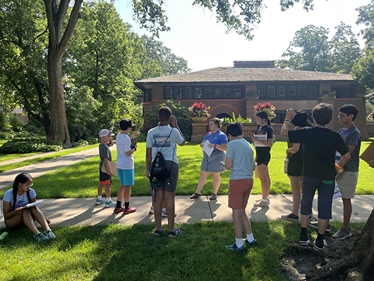 6th – 8th grade campers discuss Prairie style design features of a nearby Wright-designed home on a neighborhood walk.