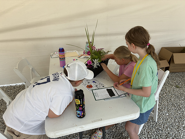 After learning about the importance of texture, color, and size in landscaping, campers design planters together.